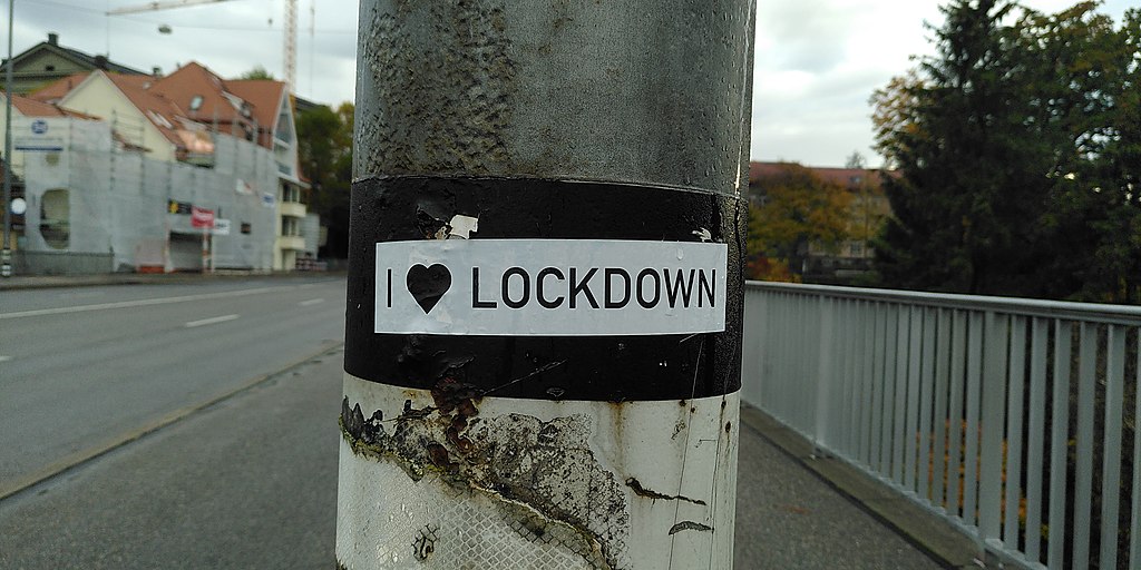Power pole with a sticker on it saying "I love lockdown"